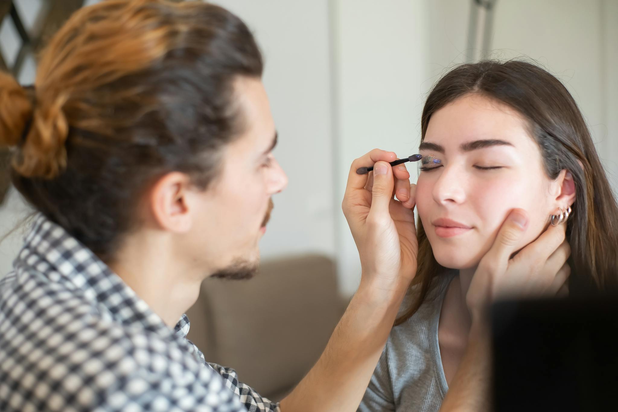 A Man Putting Makeup on a Woman